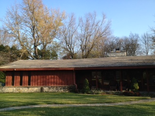 Ranch home before with tar and pea gravel roofing.